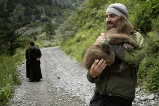 Orthodox monk in Georgia with orphaned bear cub