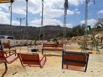 Children's playground at Qaryut spring, overlooked by Shiloh settlement  Image: EAPPI/Philippa