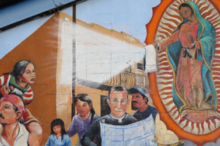 image: mural at Sacred Heart Parish in El Paso, TX of Our Lady of Guadalupe offering relief to migrants