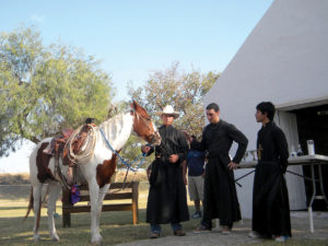 Three young men from Our Lady of Guadalupe Parish prepare to reenact story of the 'Cavalry of Christ' outside  La Lomita Chapel in Mission.