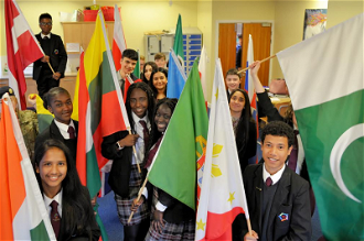 Pupils with flags represent the school's multi-cultural nature. Picture by St John Fisher High School