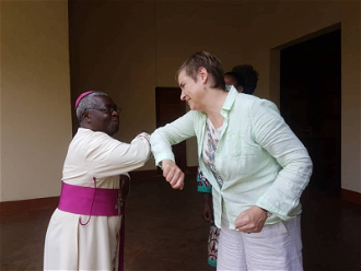 Archbishop Francois-Xavier Maroyi Rusengo greets Christin Allen - image CAFOD