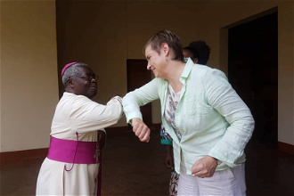 Archbishop Francois-Xavier Maroyi Rusengo greets Christin Allen - image CAFOD