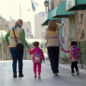 EA volunteers escort children to school in Hebron