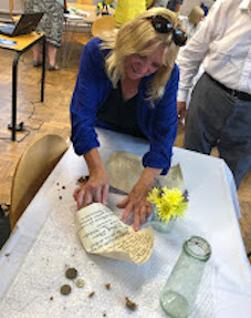 Parishioner Trisha Scott studies contents of the 1923 time capsule 