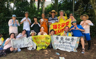 Fr Cunningham with campaigners on Jeju Island