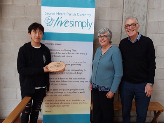Parish volunteers Si Chun Lam, Catherine and Philip Smith with the LiveSimply award