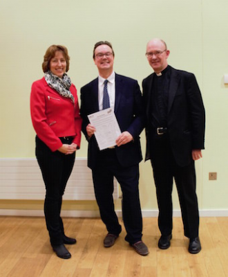 L-R: Audra Schlachter with Jonathan Lord MP for Woking, and Fr Simon with the petition they presented