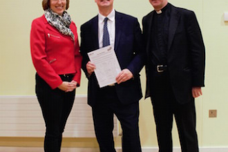 L-R: Audra Schlachter with Jonathan Lord MP for Woking, and Fr Simon with the petition they presented