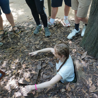 Climbing into a cramped tunnel