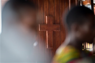 A wooden cross decorates door of a church in Liberia. Photo: Albin Hillert/LWF