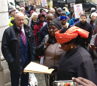 Rebecca Sharibu outside Nigerian High Commission holding petition. Image: CSW