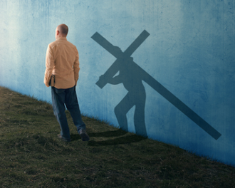 A man walking with his shadow carrying the cross, Photo 2014 © Kevin Carden / GoodSalt