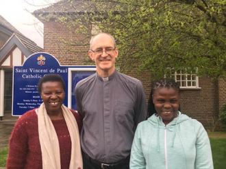 Scholastica and Lenny with parish priest Fr Mark Leenane at St Vincent de Paul's, Osterley