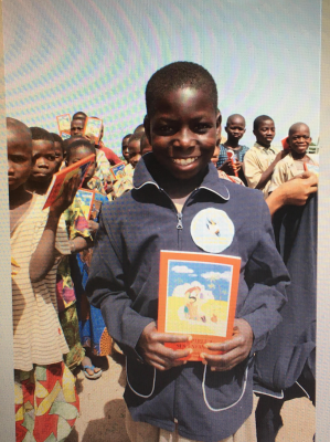 Youngster from Togo with his copy of the ACN Child's Bible (© Aid to the Church in Need