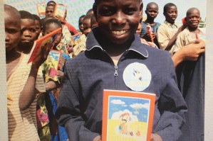 Youngster from Togo with his copy of the ACN Child's Bible (© Aid to the Church in Need