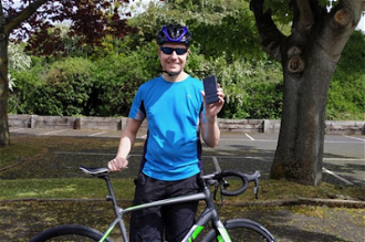 Fr Sean Connolly with his bike and phone