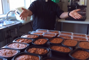 Fr Dominic McKenna, Parish Priest, preparing take-away lunches for families and food stocks at Borehamwood Foodbank.