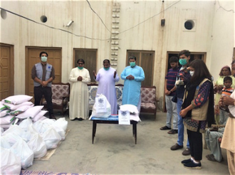 Priest blesses food for distribution to families in need © Caritas Pakistan Faisalabad