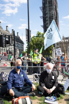 After the march, the Rt Rev Dr Rowan Williams (right) sat with a group in prayer and meditation in Parliament Square. Photo: Sean Hawkey/WCC