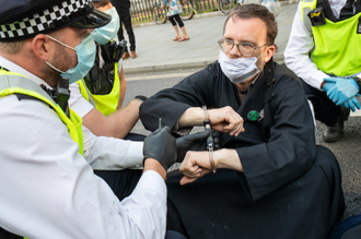 Police arrest Fr Martin Newell - Photo: Sean Hawkey/WCC