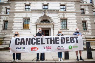 Campaigners outside Treasury call for debt cancellation. Image: CAFOD/Thom Flint