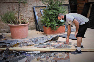 Picking up pieces of a Beirut church  window smashed in the blast - image: ACN