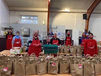 Caritas Cornerstone volunteers prepare food parcels for hungry British families