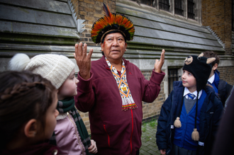 Davi Kopenawa with pupils from Our Lady of Lourdes, Wanstead, St Joseph Primary School, Putney, in 2020. Image Louise Norton/CAFOD