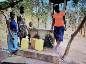 Collecting water from the new community taps