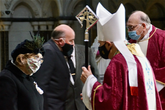 Bishop Alan Hopes talks with Lady Dannatt at Cathedral Mass in Norwich.