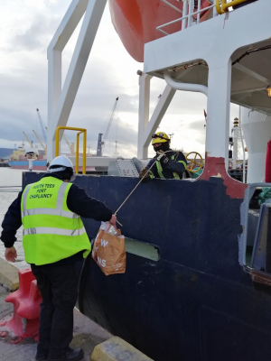 Stella Maris chaplain delivering care package to ship