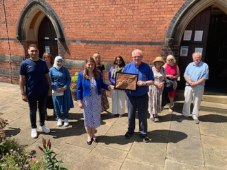 MP Theo Clarke, Canon Michael Neylon  with St Austin's parishioners and the Award.