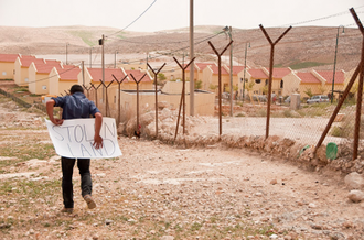 Palestinian boy protests outside Israeli settlement. Photo: Garry Walsh/Trócaire