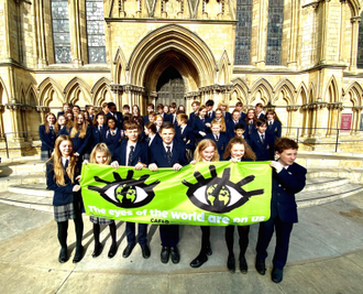 All Saints students with 'Eyes of the World' banner outside York Minster. Image: Lars B Karlsson/ Diocese of Middlesbrough