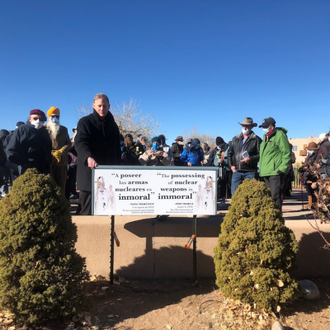 Archbishop Wester unveils sign with Pope Francis' quote in December 2021.