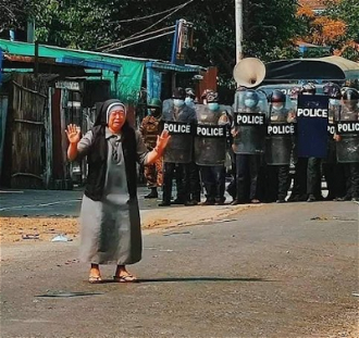 Sister Ann Nu Tawng in front of police during violent protests. Copyright unknown