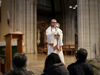 Deacon Neil with Blessed Sacrament at healing event. Photo by Emily Newton.