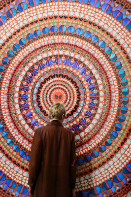 Man standing in front of Tranquility, by Damien Hirst. At White Cube Gallery 2019