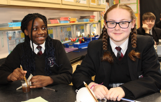 Young scientists take a break from their investigations to pose for a picture
