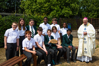 Bishop Alan Hopes with St Alban's students with their LiveSimply award in school prayer garden.