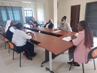 Fr Devine and the team at a planning meeting