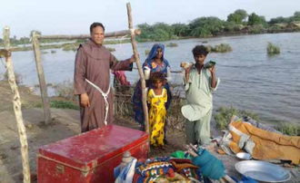 Franciscan friar with flood victims in Khipro, Sindh. Image ©ACN