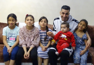 Rajabi with his five daughters at their home, two days before demolition.