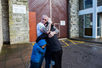 Man reunited with family on release from prison. Image Andy Aitchison