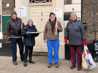 Sean Finlay and friends, holding Lamedusa cross posters outside Rose and Crown Hotel, Wisbech