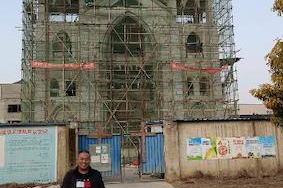 Fr Joseph Wang in front of the new church in Tianmen.