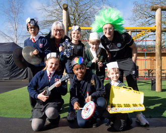 Year 4 teacher and music leader Cathy Severs and Principal Paul Madia with some of the children