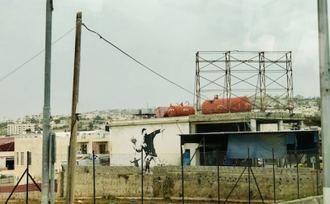 Flower Thrower (Love is in the Air),by Banksy,2005, Spray paint on wall, Bethlehem © Christian Art