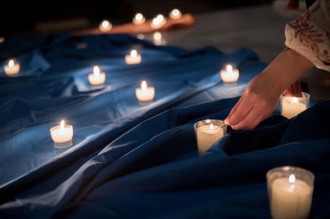 Young woman lights candles before Ecumenical Youth Gathering prayers in St Stephen Church, Karlsruhe, Germany, in lead-up to WCC 11th Assembly.  Photo: Albin Hillert/WCC